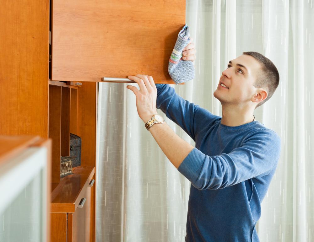 Man in drying kitchen cabinets